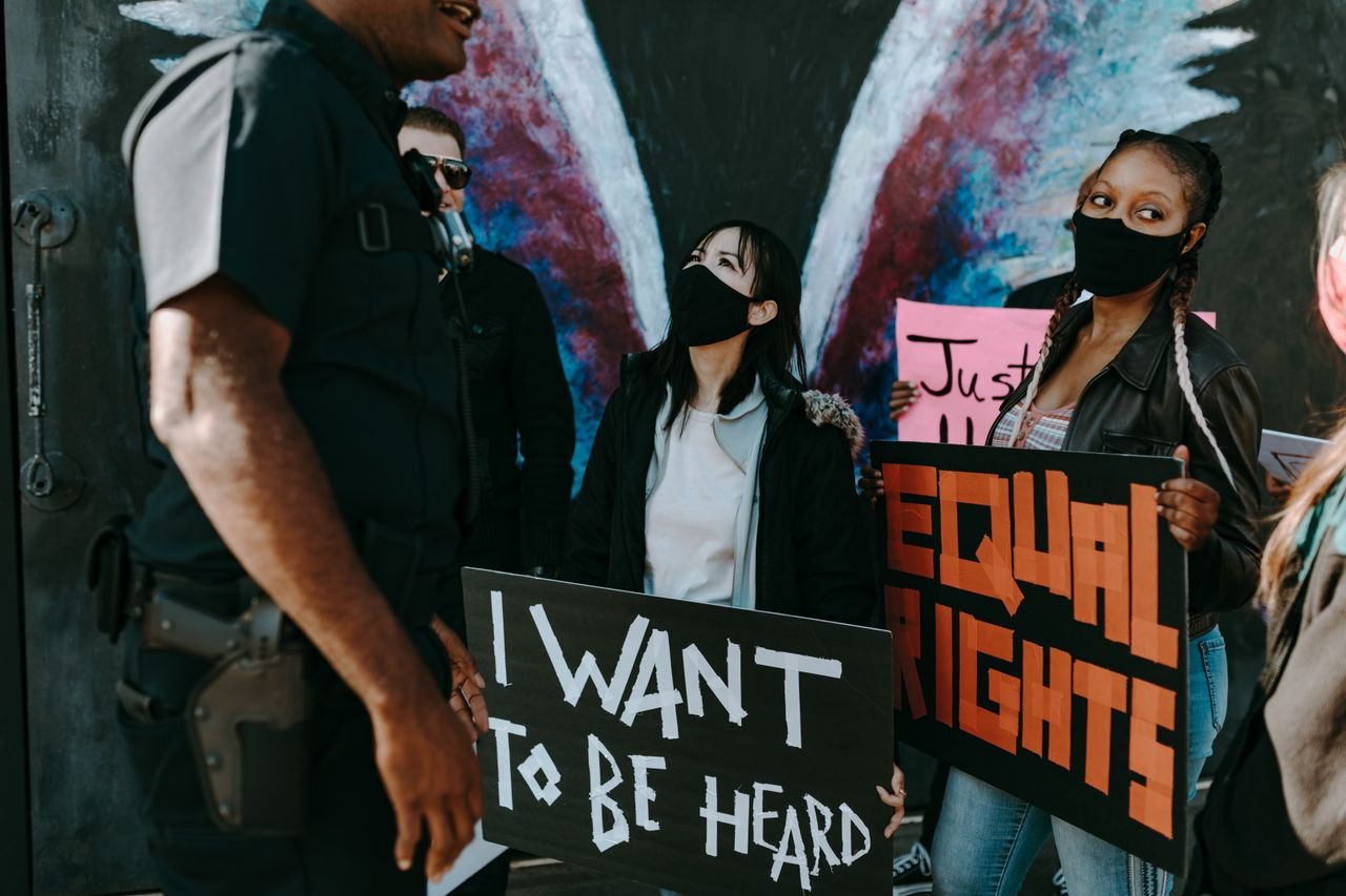 Mastering the First Impression: Your intriguing post title goes here A diverse group protests for equal rights holding banners, seeking justice and unity.